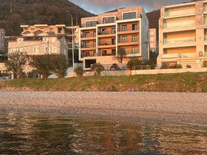 a group of buildings next to a body of water at Seafront apartment Tivat in Donja Lastva