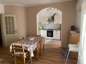 a kitchen with a table and chairs and a kitchen with a table and a table at Casa Petralia in Petralia Sottana