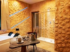 a bathroom with a table and a glass shower at suite pompei La Caverna in Pompei