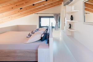 a room with a bed with pillows on it at Tempestini Exclusive Villas in Nikiana +127 photos