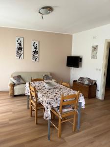 a living room with a table and a couch at Casa Petralia in Petralia Sottana