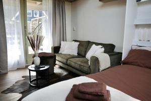 a living room with a bed and a couch at 'T Dijkhuisje - Driehuizen in Driehuizen