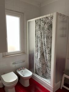 a bathroom with a shower with a toilet and a sink at Casa Petralia in Petralia Sottana +9 photos
