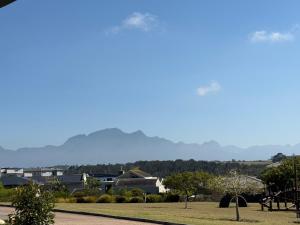 a view of a park with mountains in the background at 22 Mountain View in Herolds Bay