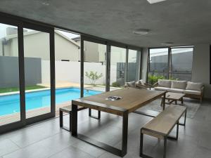 a living room with a table and a pool at 22 Mountain View in Herolds Bay