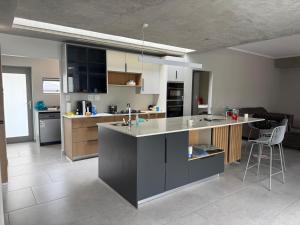 a kitchen with an island in the middle of a room at 22 Mountain View in Herolds Bay