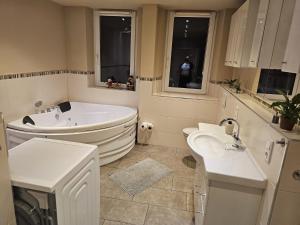 a bathroom with two sinks and a bath tub at Messe-Zimmer TuS-Treff in Düsseldorf +45 photos