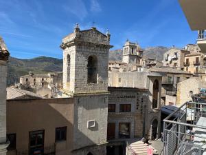 an old building with a tower on top of a city at Casa Petralia in Petralia Sottana