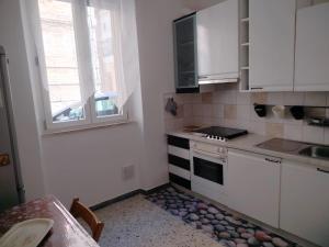 a kitchen with white cabinets and a stove top oven at L'antica Terrazzella in Vasto