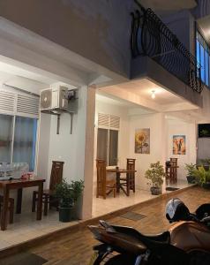 a motorcycle parked in a room with a living room at senarathna guest house in Weligama
