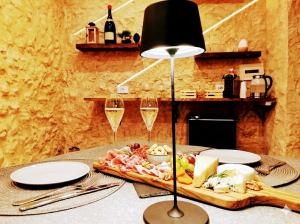 a table with a plate of food and glasses of wine at suite pompei La Caverna in Pompei