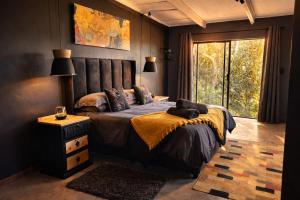 a bedroom with a large bed and a window at Gallo Vista B & B in Gillitts-Emberton