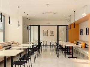 a dining room with tables and chairs at Fortune D Hotel Loei in Loei