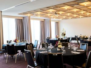 a conference room with tables and chairs and tablesktop at Mantra Albury in Albury
