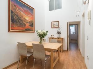 a dining room with a wooden table and chairs at Celia House in Las Palmas de Gran Canaria