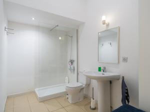 a bathroom with a toilet and a sink and a shower at Celia House in Las Palmas de Gran Canaria +16 photos