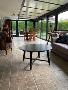 a living room with a table and a couch at Chez Nanou in Marmagne