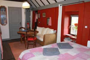 a bedroom with a bed and a table and a room at Gîte ABMA in Clugnat