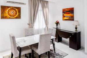 a dining room with a table and a desk at Eterniti by Amber in Lagos