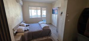 a room with a bed with pillows and a window at Еви 1 in Gabrovo +16 photos