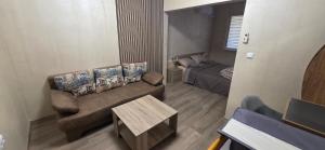 a living room with a couch and a bed at Еви 1 in Gabrovo