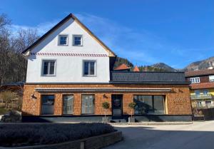a large white and brown house with a roof at ParkSuite Aflenz Kurort in Aflenz Kurort