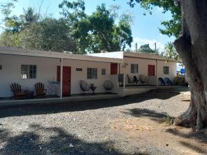 a large white building with chairs in front of it at Perfect Getaway #1 in La Libertad