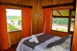 a bedroom with a bed and a large window at Riberas del Parana in Wanda +81 photos