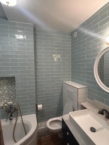a bathroom with a toilet and a tub and a sink at Le Gouvernail in Le Tréport +16 photos