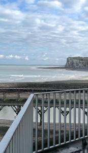 a view of a beach with a bridge and the ocean at Le Gouvernail in Le Tréport