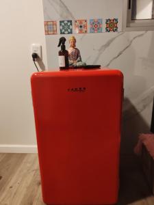 a red refrigerator with a toy on top of it at Habitación para pareja in Salinas