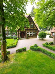 a large house with a courtyard in front of it at Heidehotel Waldhütte in Telgte
