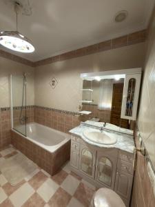 a bathroom with a tub and a sink and a bath tub at Casa Cueva Conde in Guadix +18 photos