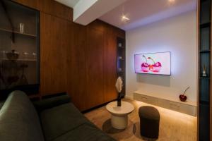 a living room with a couch and a painting on the wall at Cherry Apartments in Iaşi