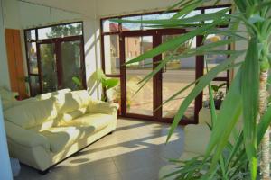 a living room with two white couches and sliding glass doors at Hotel Road Rooms in Voluntari