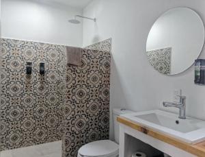 a bathroom with a toilet and a sink and a mirror at Bokatrip Xochimilco in Oaxaca City +47 photos