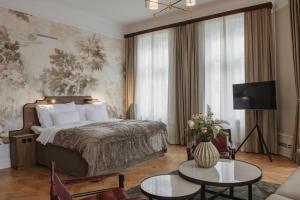 a bedroom with a bed and a living room at Home Hotel Baltzar in Malmö