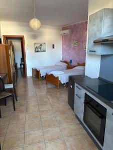 a living room with two beds and a kitchen at Vento Dell'Est in San Cataldo
