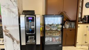 a refrigerator with food inside of it in a kitchen at Contact Hôtel Le Continental in Vierzon