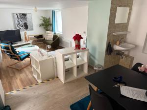 a living room and a living room with a table and a couch at Maison atypique Alsacienne in Kintzheim