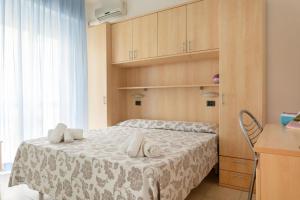 a bedroom with a bed with a white blanket at Nautilus Hotel in Bellaria-Igea Marina +26 photos