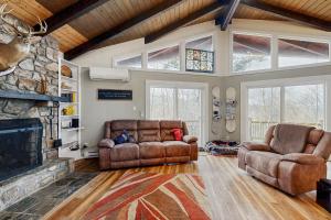 a living room with two couches and a fireplace at Sugar High in Sugar Mountain