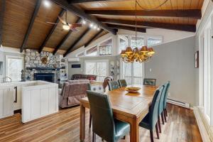 a kitchen and dining room with a wooden table and chairs at Sugar High in Sugar Mountain