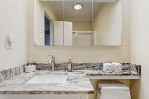 a bathroom with a sink and a toilet and a mirror at Sugar High in Sugar Mountain +18 photos