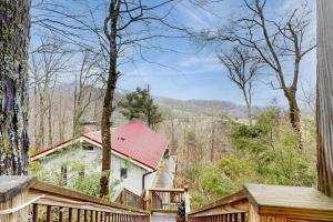 a house with a red roof in the woods at Sugar High in Sugar Mountain