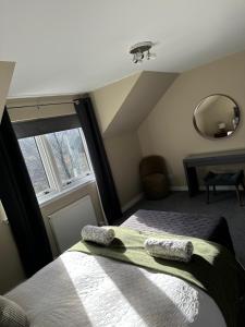 a bedroom with two beds and a large window at Coiseag at Maol Ruadh, Roy Bridge, near Ben Nevis in Roybridge