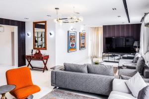 a living room with a couch and a table at Eterniti by Amber in Lagos