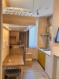 a small kitchen with a table and a bunk bed at apartamente Melodi in Durrës +65 photos