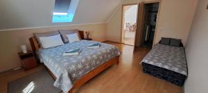 a bedroom with a large bed and a window at Villa Maria in Egerszalók