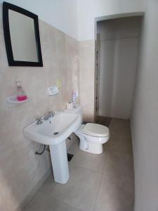 a bathroom with a white sink and a toilet at Linda Goya in Goya +27 photos